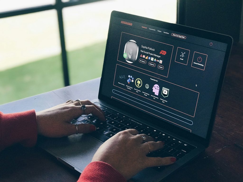 Marketing professional working on a business website on a laptop